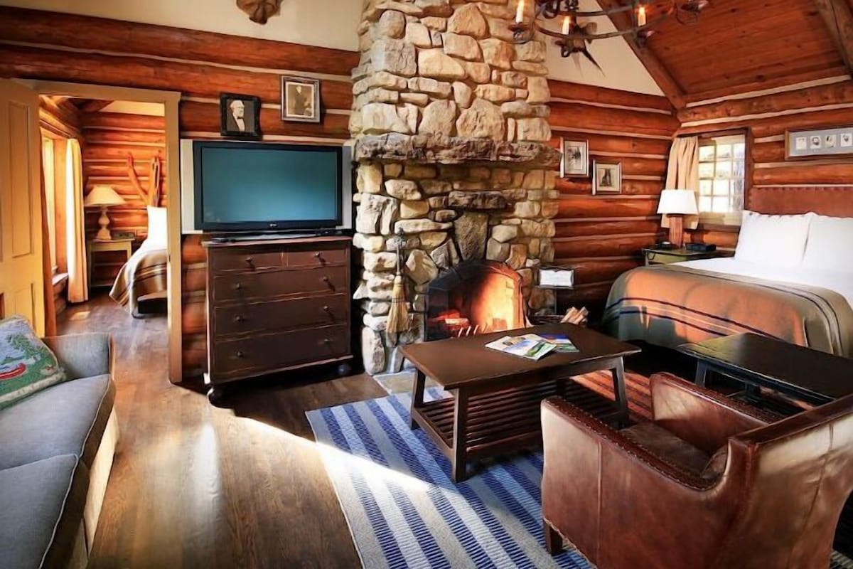 The lounge at Casa Alta — linen sofas, fireplace, warm lamplight