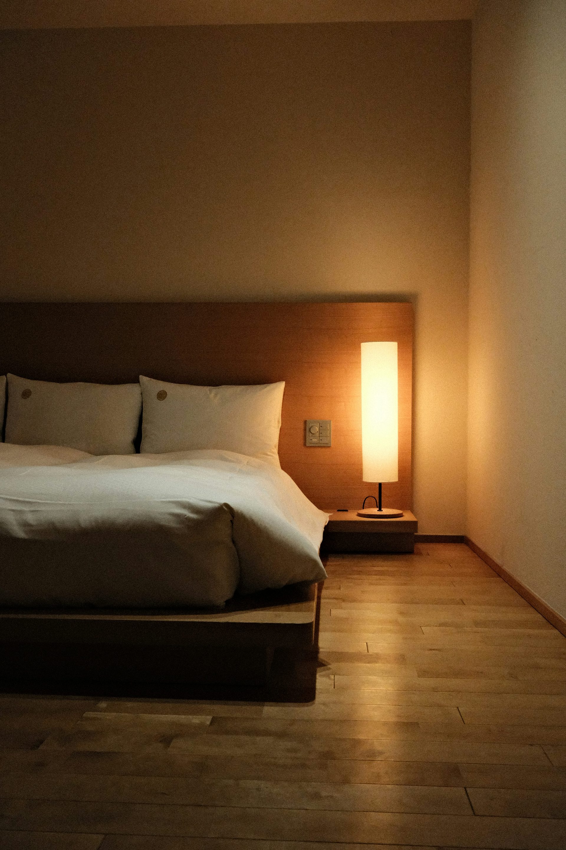 Quarto Jardim — minimal warm bedroom opening onto the garden